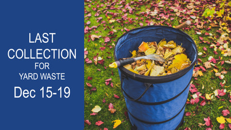 A leaf container filled with leaves and a small rake, sitting on grass covered in leaves with message: Last Collection for Yard Waste Dec 15-19.