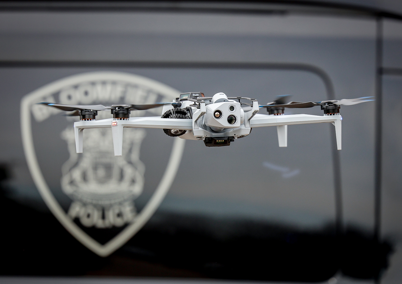 Close up of Drone flying in front of Police Vehicle