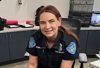 Female Animal Welfare Officer Elizabeth Summerfield seated at desk inside Animal Shelter